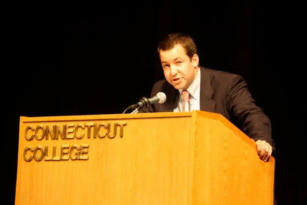 Nate speaking at a podium at Connecticut College