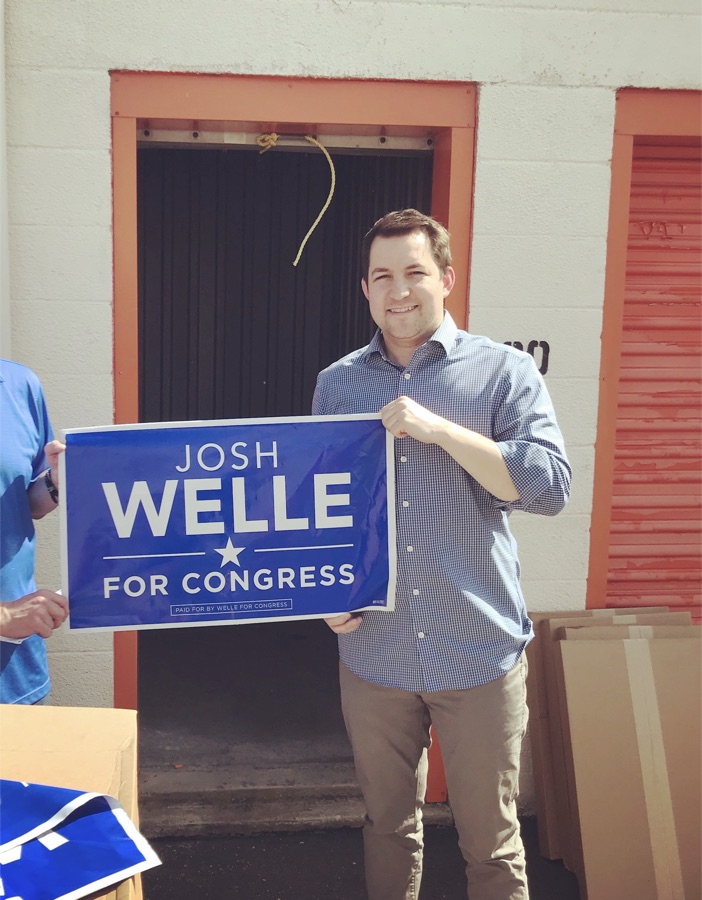 Nate holding a Josh Welle for Congress campaign sign
